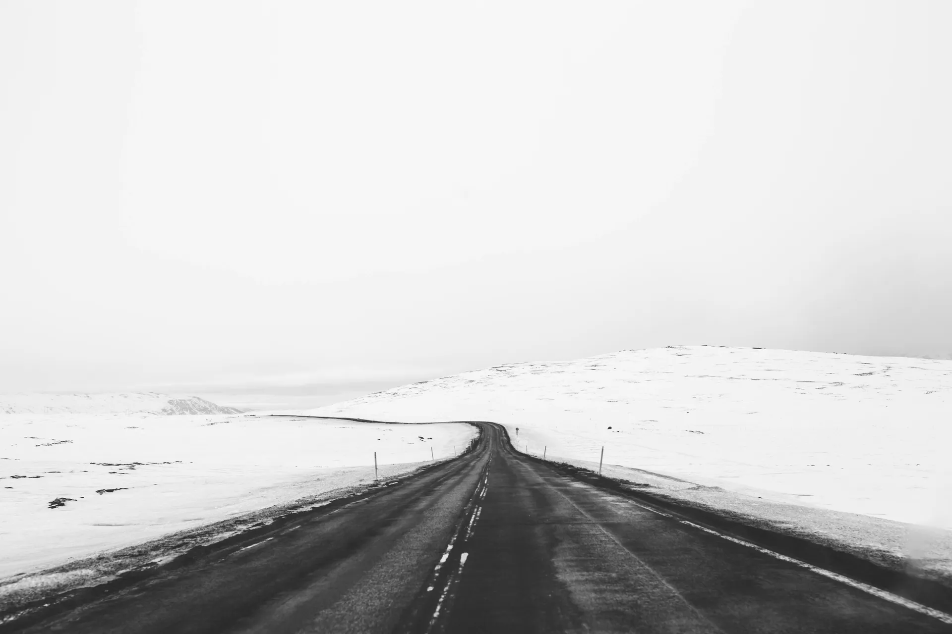 A snowy road in Alaska, stretching into the distance.